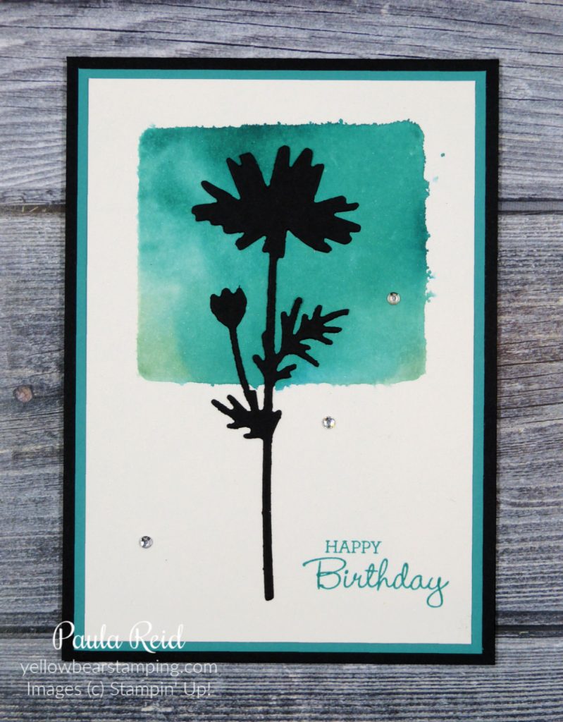 Clear block, ink and a water spritzer to create a cool background for stamped or die cut images