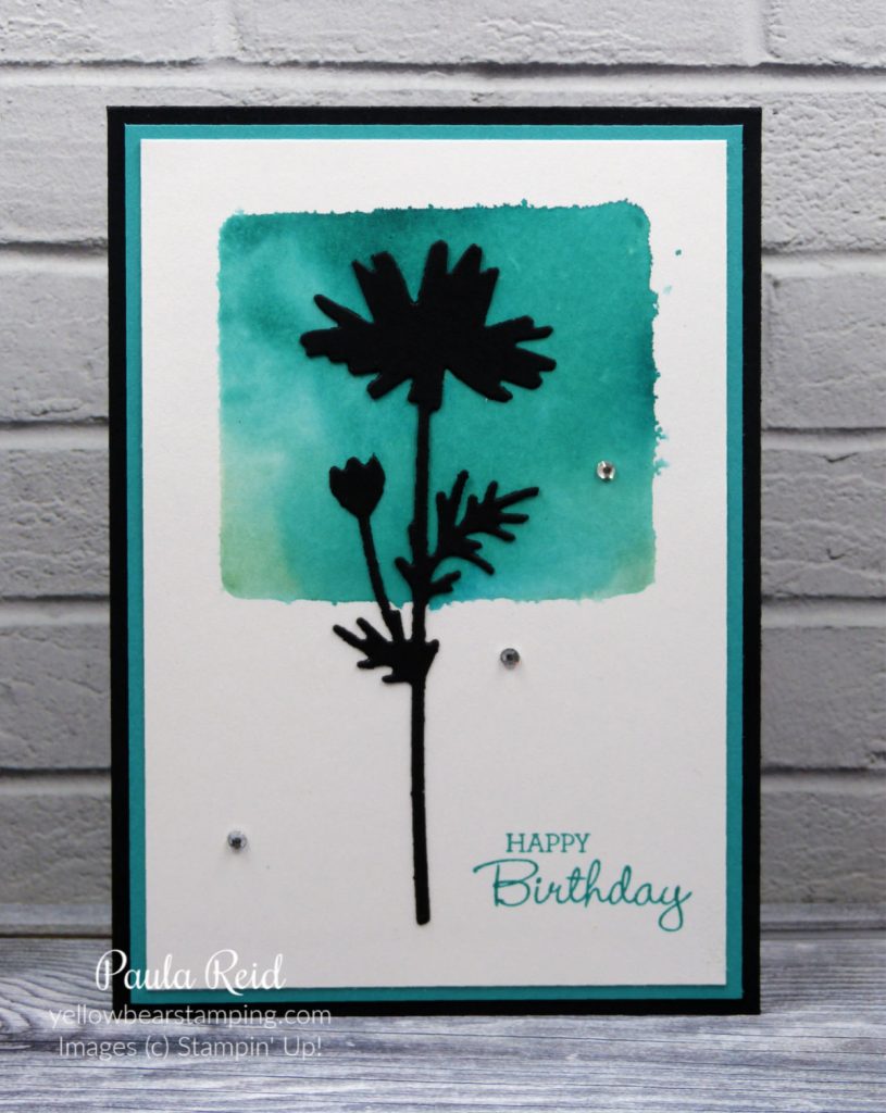 Clear block, ink and a water spritzer to create a cool background for stamped or die cut images