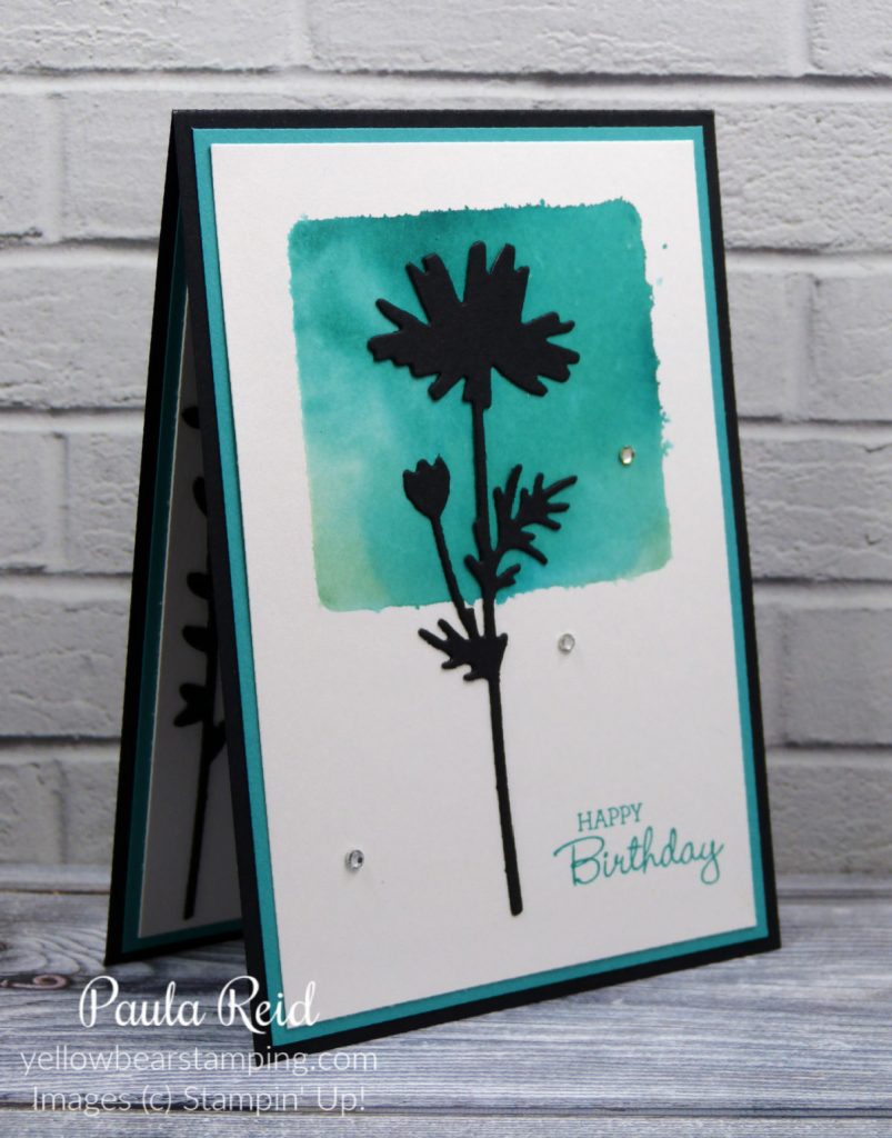 Clear block, ink and a water spritzer to create a cool background for stamped or die cut images
